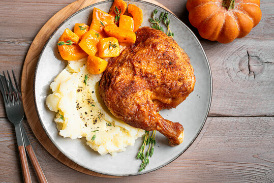 Autumn meal: roasted chicken quarter with pumpkin and mashed potato