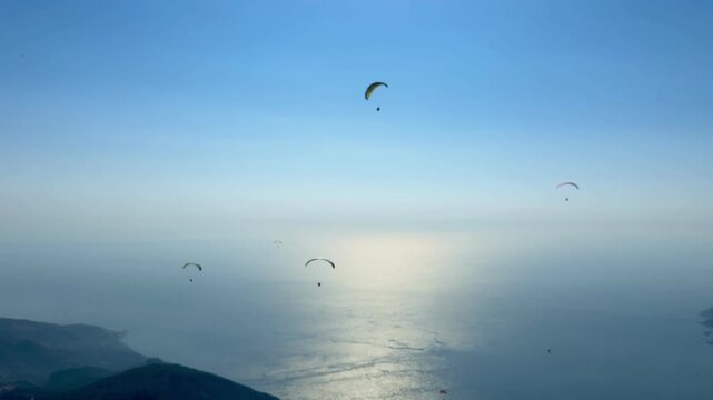 Paragliding at sunset on Babadağ mountain, 4k video. Fethiye, Muğla, T&uuml;rkiye.