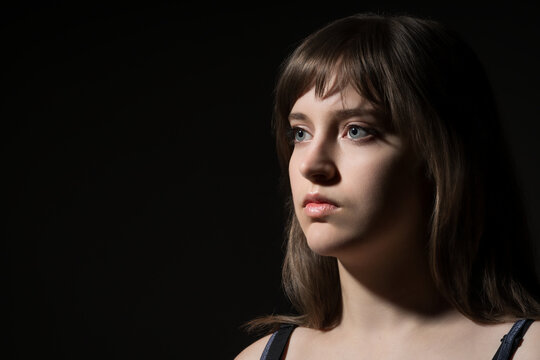 Beautiful teenage girl posing in beauty portrait style on dark background