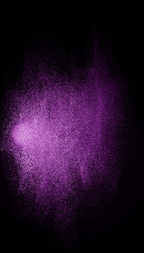 Purple particles dispersing in a dark abstract cloud