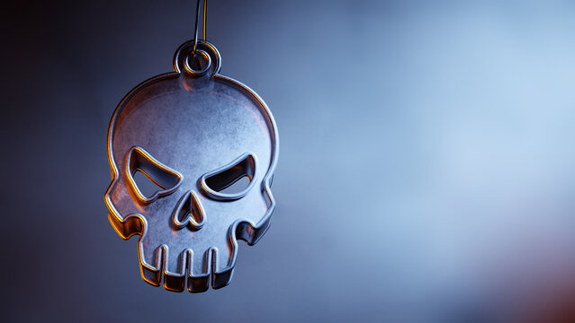 Metallic Halloween skull ornament on a soft misty dark background.