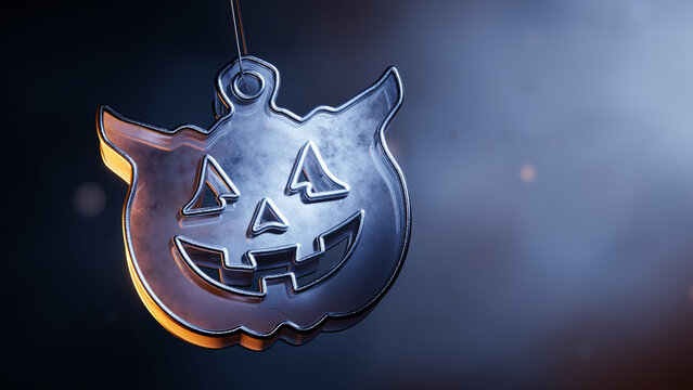 Metallic Halloween jack o lantern ornament on a misty background.