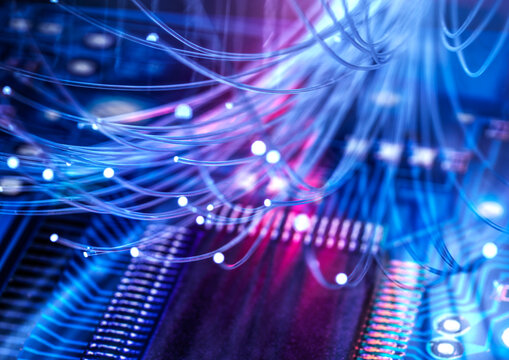 Glowing fiber optic cables over a computer chip for cloud computing