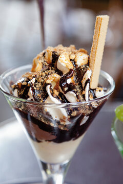 Close up of brittle sundae made with mocha icecream, whipped cream and chocolate sauce