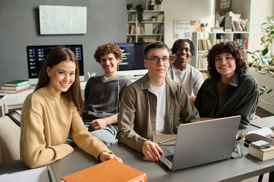 Diverse student group studies IT on a laptop in the classroom