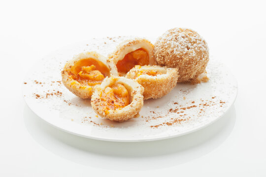 Apricot dumpling in plate on white background