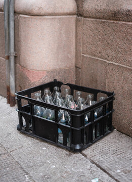 Empty Milk Bottles In Crate On Doorstep