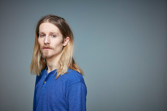 Portrait of young man with long blond hair and beard