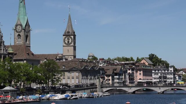 View of the historic St. Peter Church and Fraumunster clock towers overlooking the Limmat river in the city center of Zurich, Zurich, Switzerland.