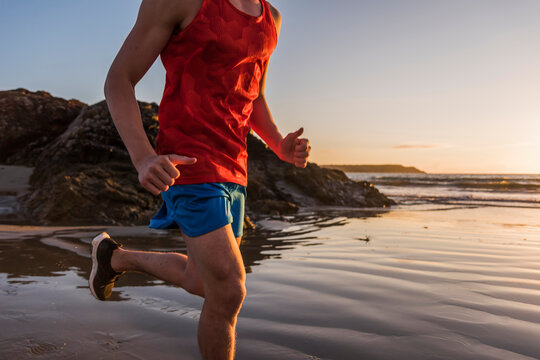 France, Crozon peninsula, jogger on the beach at sunset