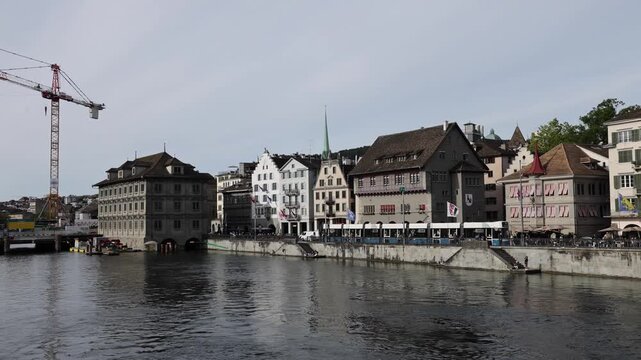View of historic buildings and the Limmat riverfront in the city center of Zurich, Zurich, Switzerland.