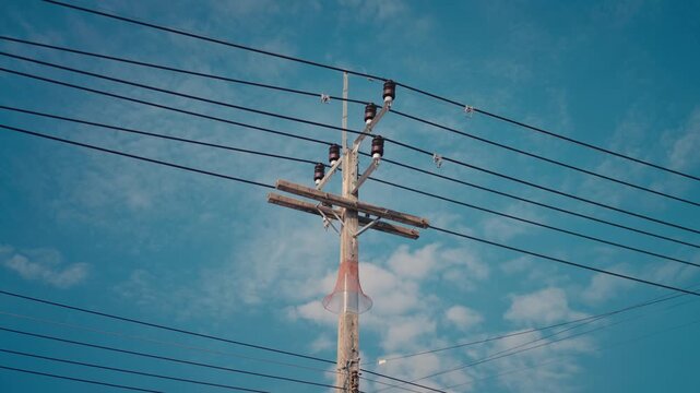 Low angle of wooden utility pole against blue sky in Koh Phangan
