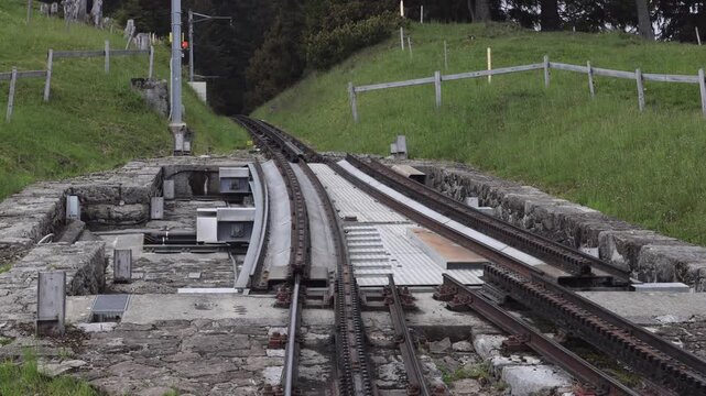 View of the Pilatus Railway rack track with stone masonry and green slopes in Alpnach, Obwalden, Switzerland.