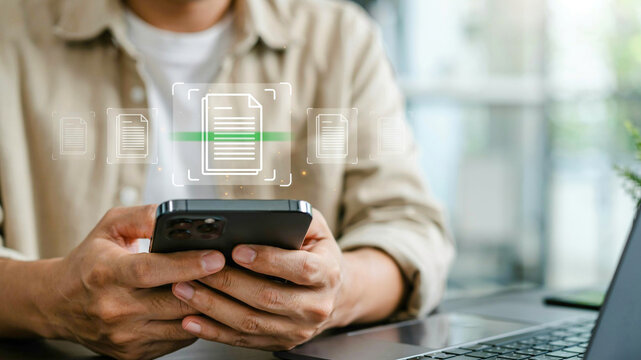 Close up of man using mobile phone app to scan documents and manage files