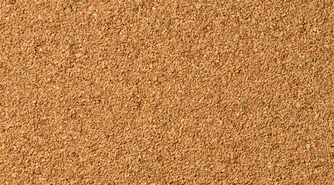 A cork board with a natural texture and a detailed granular surface as the background