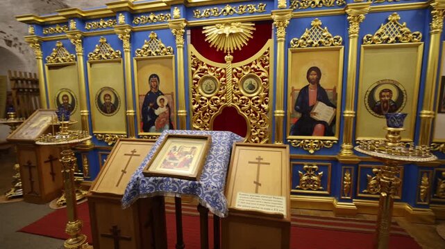View of the ornate iconostasis with gold and blue details inside a historic church at the Solovetsky Islands in Solovetsky, Arkhangelsk Oblast, Russia.