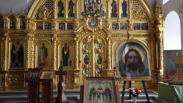 View of the ornate golden iconostasis and religious icons inside the historic church at Solovetsky Monastery in Solovetsky, Arkhangelsk Oblast, Russia.