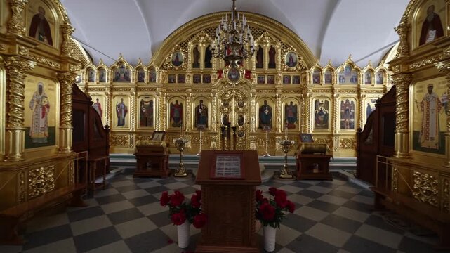 View of the ornate golden iconostasis and religious icons inside the historic church at Solovetsky Monastery in Solovetsky, Arkhangelsk Oblast, Russia.