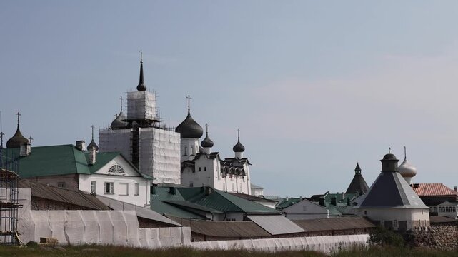 View of Solovetsky Monastery with its iconic onion domes and stone walls under restoration on Solovetsky Islands, Solovetsky, Arkhangelsk Oblast, Russia.