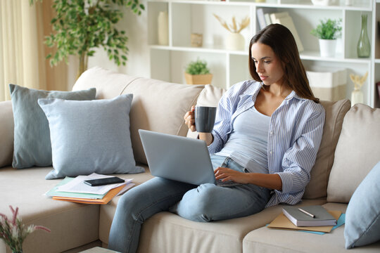 Telecommuter working online and drinking coffee