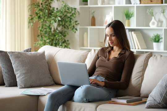 Telecommuter using laptop to work at home