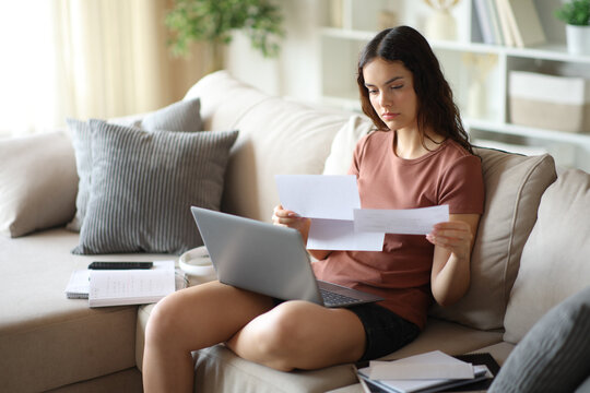 Young student reading paper letter at home