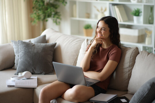 Happy student thinking in future studying at home