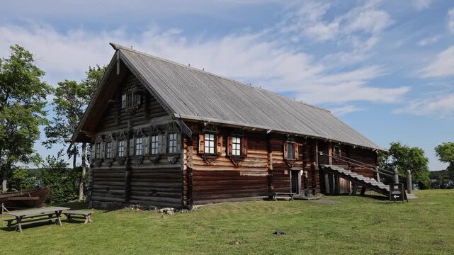 View of traditional wooden log architecture of the Kizhi Pogost with intricate timber craftsmanship and a wooden staircase in Petrozavodsk, Republic of Karelia, Russia.