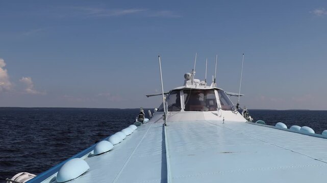 View of a hydrofoil boat navigating across the open water of Lake Onega in Petrozavodsk, Republic of Karelia, Russia.