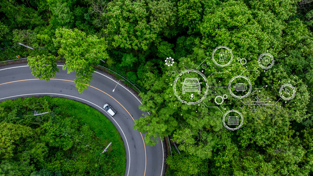 Electric vehicle or EV electrical energy for environment on forest road, Sustainable energy transportation, Electric car and EV electric energy for environment.