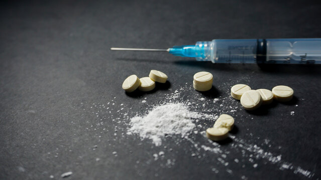 syringe and pills. Misused concept of drugs. 