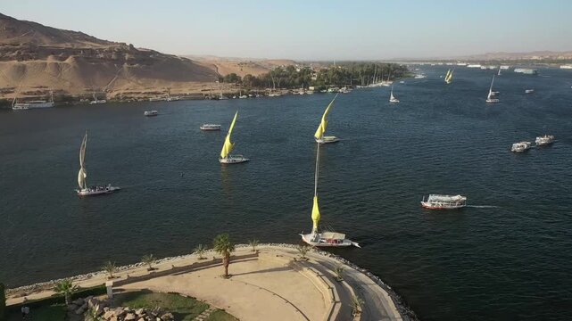 Aswan Egypt Traditional Felucca Sailboats On Nile River Panning Left Aerial DJI Drone Raw Footage