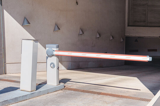 Automatic boom arm barrier blocking vehicle access to a parking garage, ensuring security and controlled entry