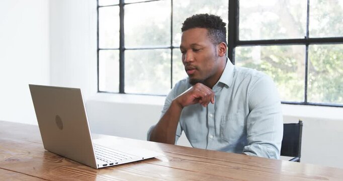 Lifestyle videos indoor of people doing activities at office, working on laptop, man in casual shirt