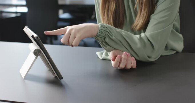 Close up of people talking to the camera, gesturing while video conferencing, woman using tablet on