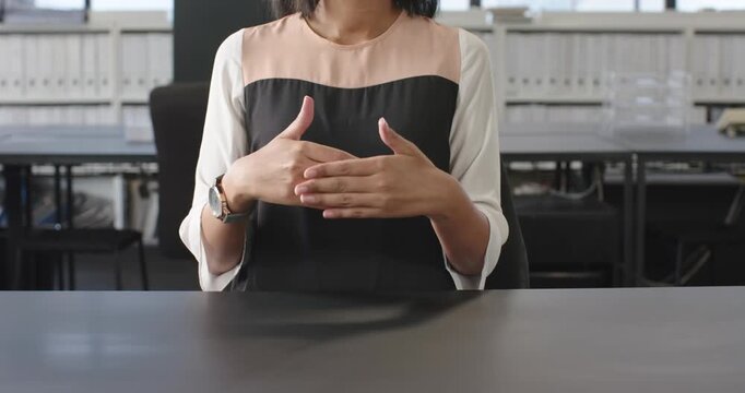 Close up of people talking to the camera, using sign language, woman communicating at office desk in