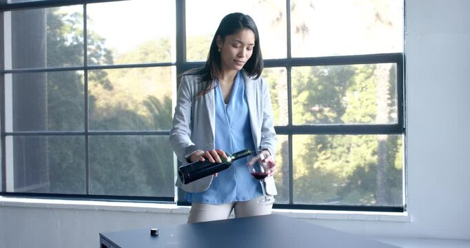 Lifestyle videos indoor of people doing activities at office, businesswoman drinking wine and relaxi