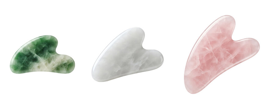 Three heart-shaped jade rollers for facial massage on transparent background