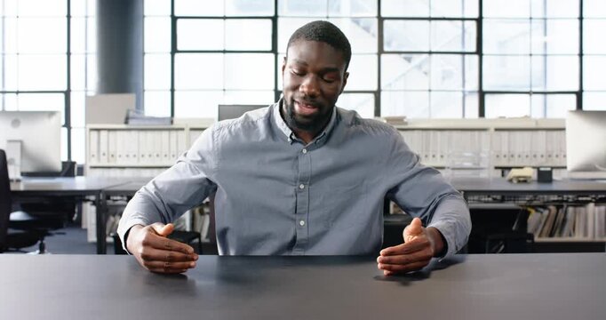 Close up of people talking to the camera, businessman in office pointing at table, focusing on work