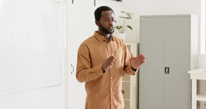 Lifestyle videos indoor of people doing activities at office, presenting in office, man standing nea