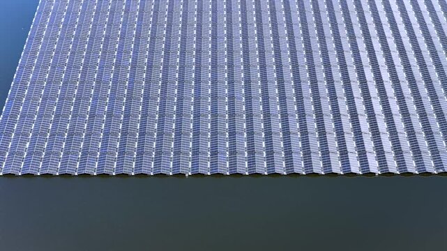 View of floating solar panels arranged in rows on the surface of a calm lake in Ureterp, Friesland, Netherlands.