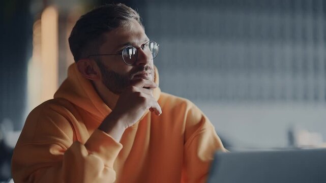 Thoughtful Man With Eyeglasses Sitting In Cafe, Working With Laptop, Medium Portrait Of Freelancer