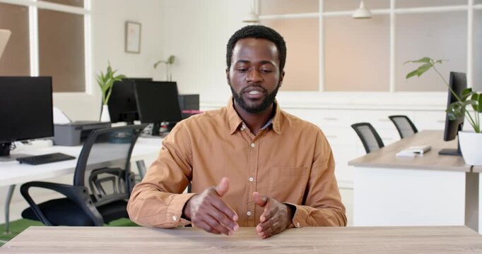 Close up of people talking to the camera, businessman in office pointing at desk, focusing on work i