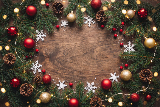 Christmas Wreath Garland with Orbs and Pinecones: A festive Christmas wreath constructed from evergreen boughs, adorned with glittering baubles, sparkling fairy lights, and natural pinecones.