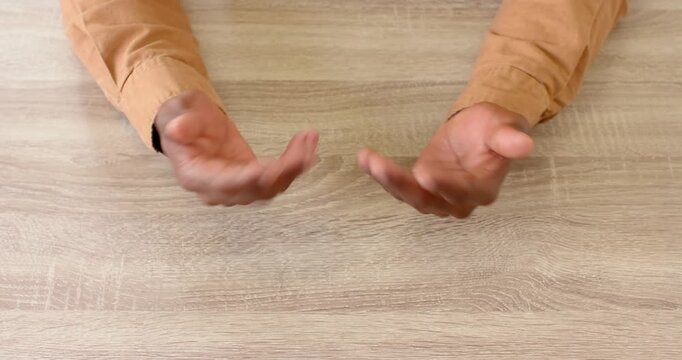 Close up of people talking to the camera, gesturing with hands, person explaining concept on wooden