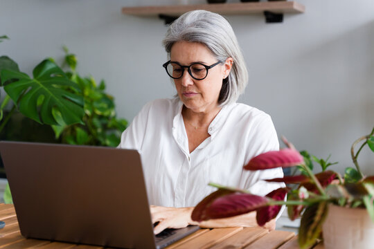 White Woman typing on laptop