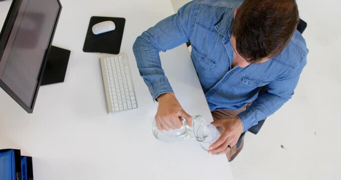 Lifestyle videos indoor of people doing activities at office, man sitting at desk with computer and