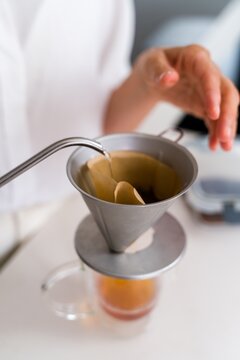 Pouring hot water into coffee filter for drip brewing