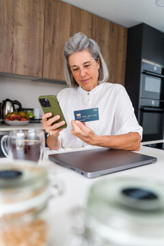 White Woman using smartphone and credit card for online payment