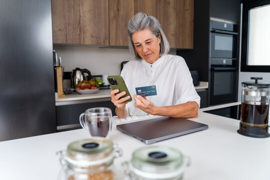 White Woman using smartphone and payment card for online shopping